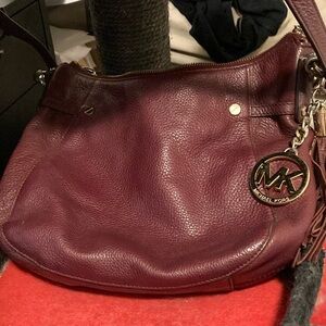 Maroon Michael Kors crossbody hobo bag